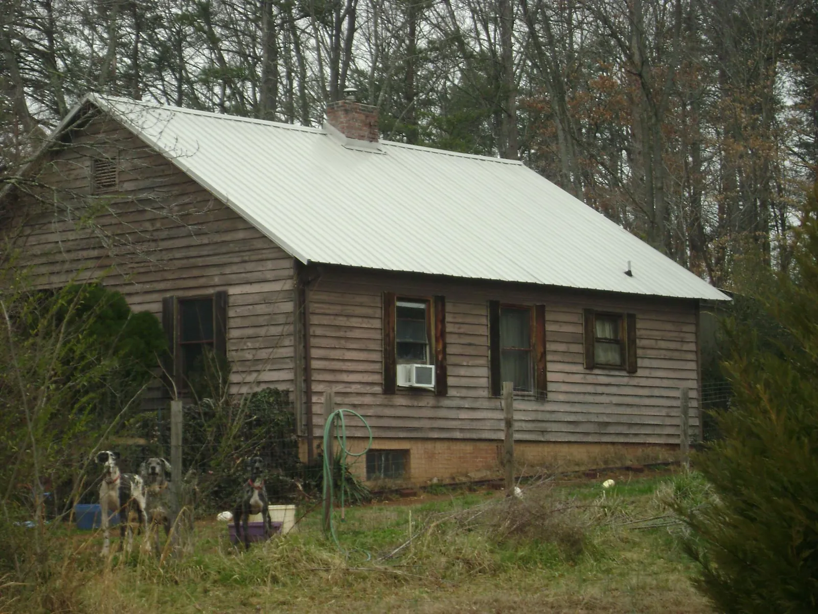 White metal roof on an old wood sided farmhouse, from a Metal Roof Installation job in Springboro